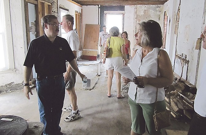 Sam Bushman, left, chats with Donna Viessman during a previous "Hidden Spaces, Secret Places" tour of downtown Jefferson City loft areas. This loft area is at 130 E. High St.