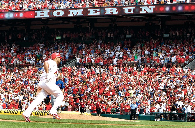 Albert Pujols rounds third and heads home after hitting a walkoff home run in the 10th inning of Sunday's 3-2 victory over the Cubs at Busch Stadium.