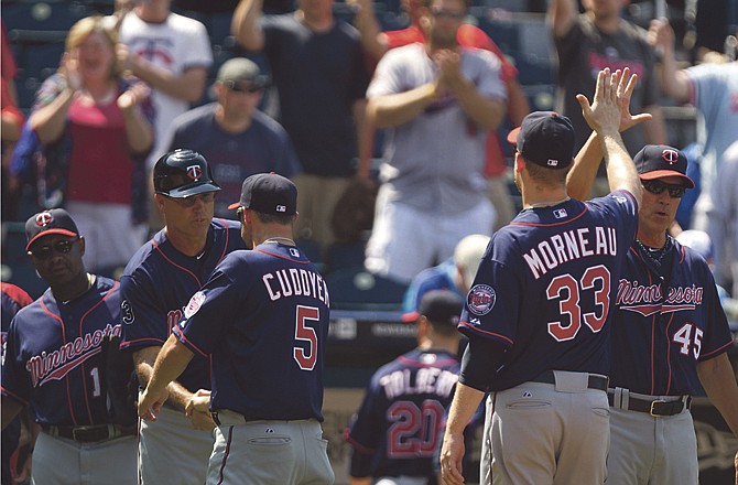 Minnesota Twins fans celebrate as the team comes off the field after winning a baseball game against the Kansas City Royals Sunday, June 5, 2011, in Kansas City, Mo. The Twins won the game 6-0 to sweep the Royals in the four-game series.