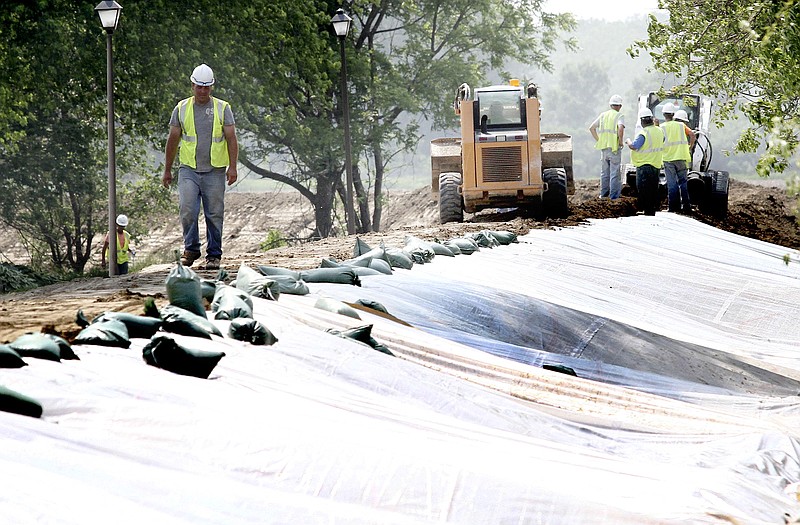 Workers build a levee Tuesday in South Sioux City, Neb. Communities along the Missouri River are battling flooding and keeping an eye on water levels in the wake of record high releases from upstream Missouri River reservoirs. 