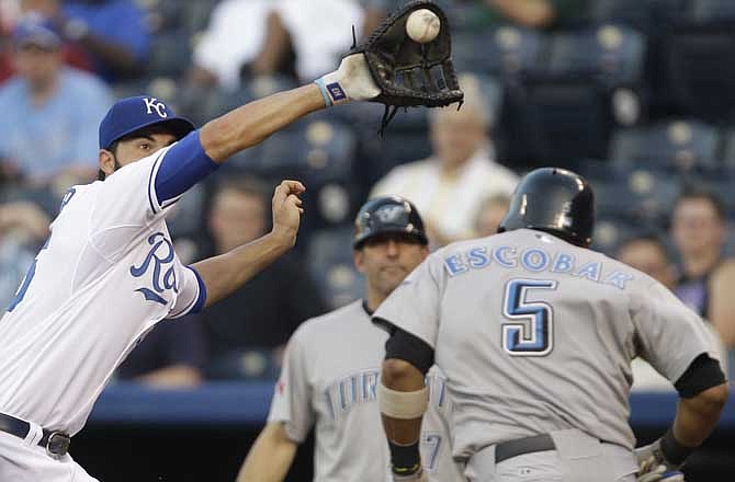 Toronto Blue Jays' Yunel Escobar (5) gets past Kansas City Royals first baseman Eric Hosmer (35) during the fourth inning of a Major League Baseball game in Kansas City, Mo., Monday, June 6, 2011. Escobar reached on an error by Kansas City Royals third baseman Mike Aviles. 