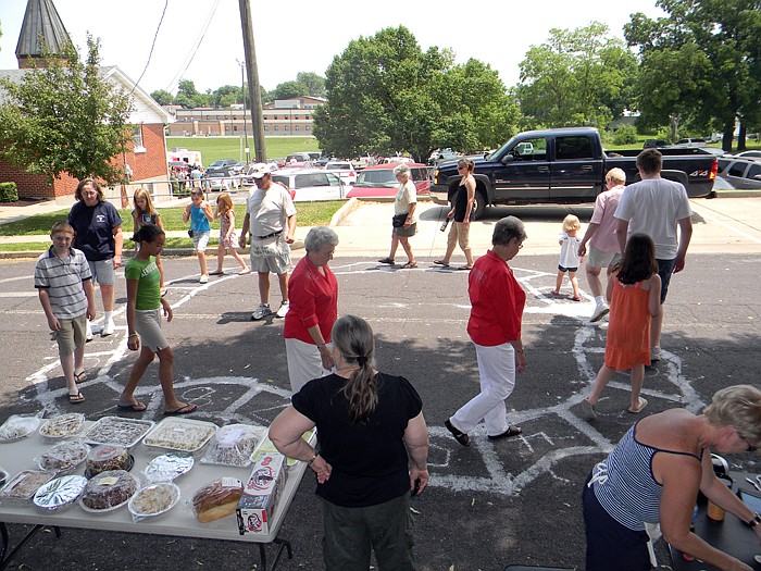 Contestants walk for cake and other baked goods at the church picnic's Cake Walk.