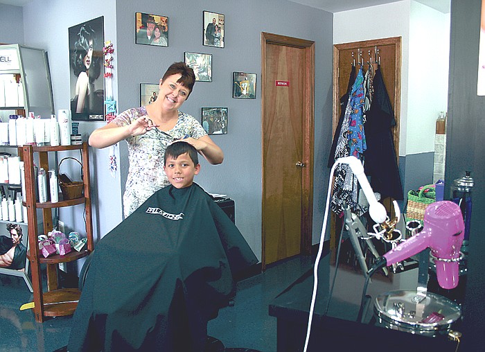Melissa Weis, California, joined the staff at Something Sassy, California, in April. Above, Weis combs through Brandon Feltrop's hair Thursday afternoon. Feltrop, 9, son of Kevin and Cindy Feltrop, California, stopped by the salon with his grandmother Ruth Ziehmer, California.