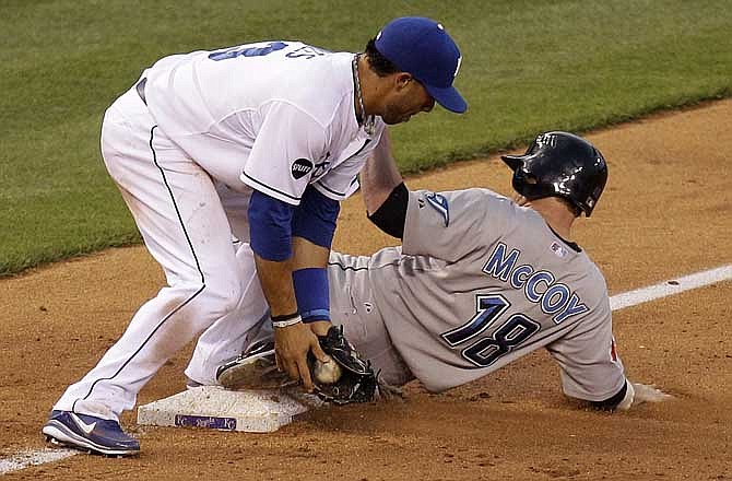 Toronto Blue Jays' Mike McCoy (18) beats the tag by Kansas City Royals third baseman Mike Aviles to advance to third on a single by Corey Patterson during the fifth inning of a baseball game Tuesday, June 7, 2011, in Kansas City, Mo. 