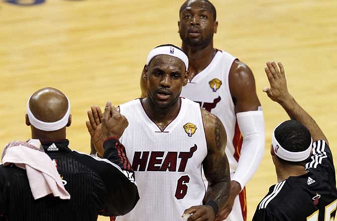 Miami Heat's LeBron James (6) and Dwyane Wade leave the floor at the end of the first half during the first half of Game 1 of the NBA Finals basketball game against the Dallas Mavericks, Tuesday, May 31, 2011, in Miami. Eddie House (55) is at right. 