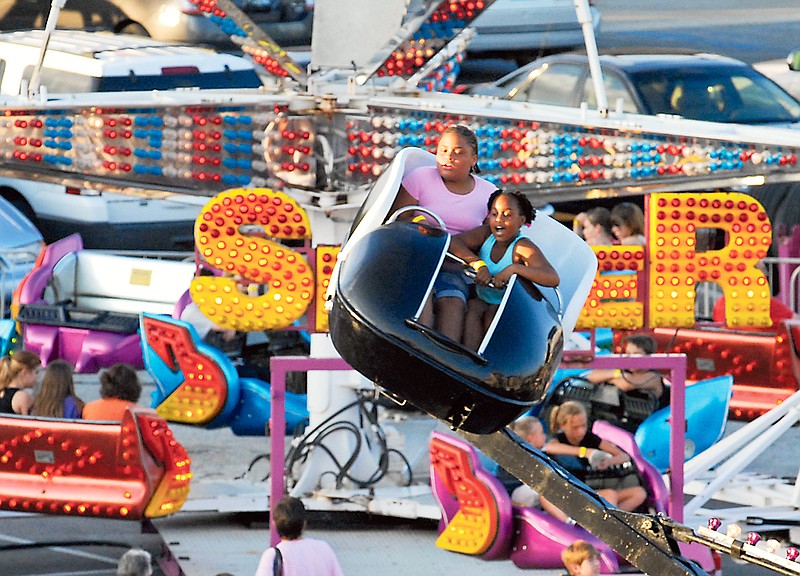 Children spin around on a ride at the Fulton Street Fair. Carnival rides will again be featured at this year's fair June 17-18.