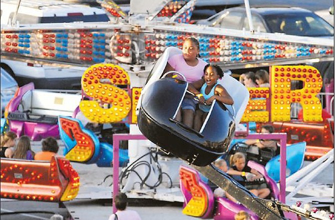 Children spin around on a ride at a previous Fulton Street Fair in this file photo.