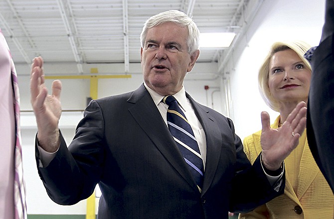 In this June 8, 2011 file photo, Republican presidential hopeful, former House Speaker Newt Gingrich, accompanied by his wife Callista Gingrich, speaks in Hudson, N.H.  Gingrich's campaign manager and numerous other key aides have resigned together, a strong blow to his hopes for the Republican presidential nomination.