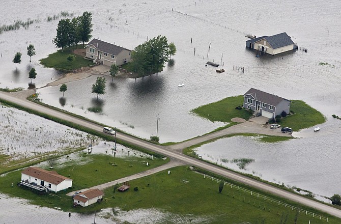 Homes sit in floodwater Monday near Bartlett, Iowa. The rising Missouri River has ruptured two levees in northwest Missouri, sending torrents of floodwaters over rural farmland toward the Iowa town of Hamburg and the Missouri resort town of Big Lake.
