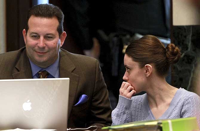 Casey Anthony talks to defense attorney Jose Baez during her trial, Saturday, June 11, 2011, at the Orange County Courthouse, in Orlando, Fla. Anthony, 25, is charged with murder in the 2008 death of her daughter Caylee. 