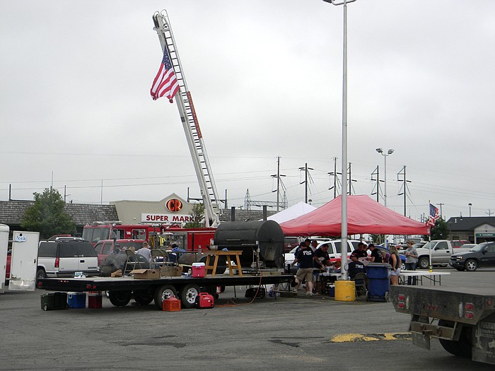 An American flag attached to a ladder truck hovered over the California Fire Department Annual Barbecue Fundraiser held Saturday, June 11, at the Village Green Shopping Center.