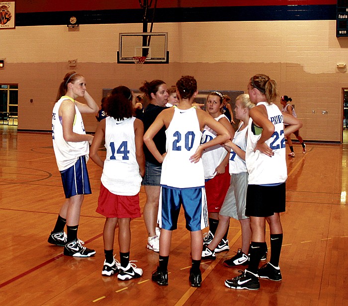 California High School Assistant Basketball Coach Barb Whittle, center, instructs some of the girls in grades 9-12 Wednesday at the California Lady Pinto Basketball Camp.