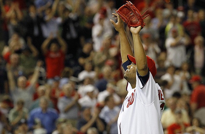 Nationals pitcher Livan Hernandez reacts as the crowd cheers after he pitched a three-hitter in the Nationals' 3-0 win over the Cardinals on Wednesday.