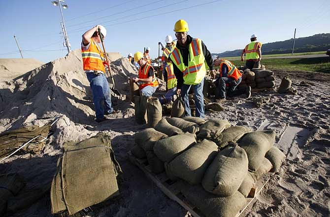 UPSTREAM: Workers fill sandbags that will be used on levees holding back rising flood waters from the nearby Missouri River, Wednesday, June 15, 2011, in Hamburg, Iowa. Breaches in levees in northwest Missouri have flooded farmland. Meanwhile, residents farther downstream in Missouri are bracing for rising water to reach them by reassessing their flood plans. (AP Photo/Charlie Neibergall)