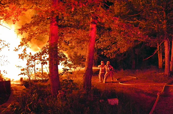 Mid-County Fire Protection District firefighters battle a blaze at a Camdenton residence off Ball Park Road on Wednesday evening. Firefighters and assisting units got the fire under control in an hour, but the home was destroyed. No injuries were reported.