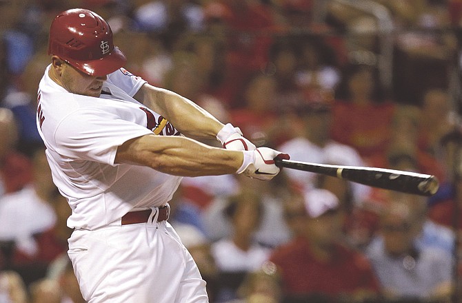 St. Louis Cardinals' Matt Holliday hits a two-run home run during the eighth inning of an interleague baseball game against the Kansas City Royals, Saturday, June 18, 2011, in St. Louis. 