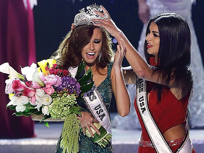 Alyssa Campanella, Miss California, is crowned as the 2011 Miss USA by Miss USA 2010 Rima Fakih, Sunday, June 19, 2011, in Las Vegas.  (AP Photo/Julie Jacobson)
