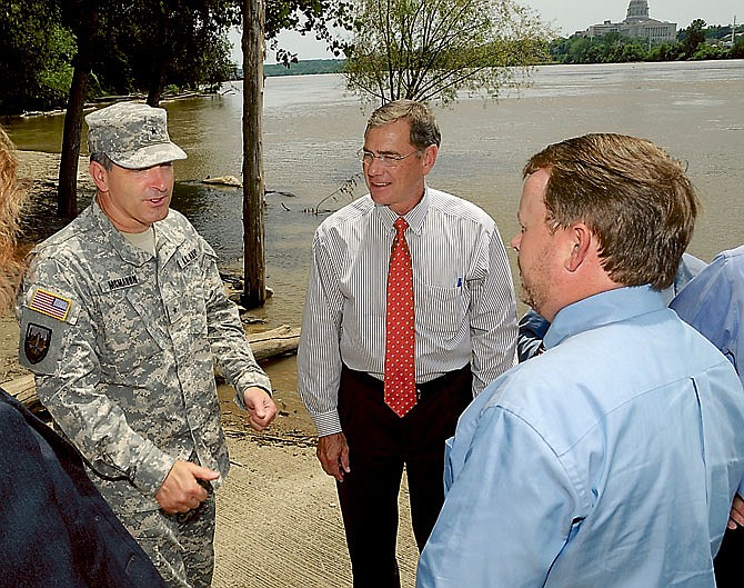 Brig. Gen. John McMahon of the U.S. Army Corps of Engineers, at left, visits with Jefferson City Mayor, Eric Struemph, at right, and U.S. Representative, Blaine Luetkemeyer (MO-9), in background. They and U.S. Rep. Vicky Hartzler (MO-4) were in Jefferson CIty to hear from stakeholders who may be adversely affected by possible flooding in the Missour River bottomlands this summer. They were in city council chambers, visited the Jefferson City airport and the Noren Conservation Access to get a first hand look at the rising water levels. 