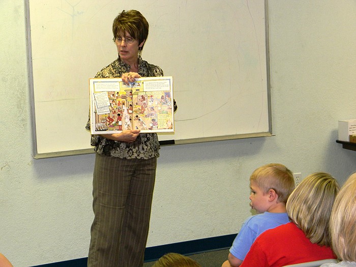 Wood Place Public Library Director Connie Walker reads "Ms. Frizzle's Adventures: Ancient Egypt" to children as part of the Summer Reading Program Thursday, June 16. Storytime activities are  each Thursday at 6:30 p.m. from May 26 - Aug. 11.