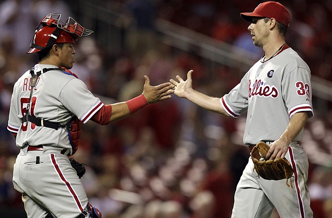 Phillies starting pitcher Cliff Lee, right, is congratulated by teammate catcher Carlos Ruiz after throwing a complete game to defeat the Cardinals  on Wednesday.