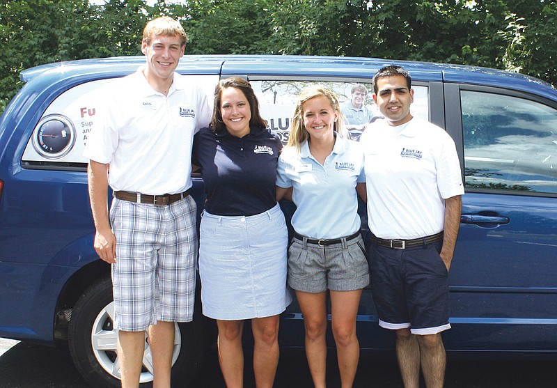 From left, Westminster senior Kelsey Weymuth, Nicki DiSalvo, senior Rachel Backes and junior Gaurev Khanal stand in front of the Blue Jay Across the U.S.A. van on Tuesday. The group will travel 6,000 miles in five weeks across the country as ambassadors for the school.