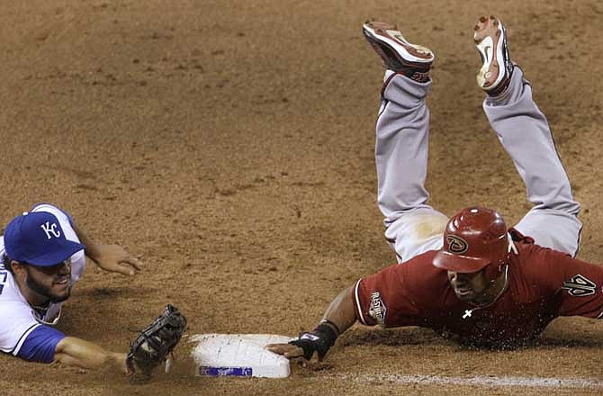 Kansas City Royals first baseman Eric Hosmer, left, beats Arizona Diamondbacks' Chris Young back to first base for the second out of an unassisted double play hit into by Stephen Drew during the ninth inning of an interleague baseball game, Wednesday, June 22, 2011, in Kansas City, Mo. 