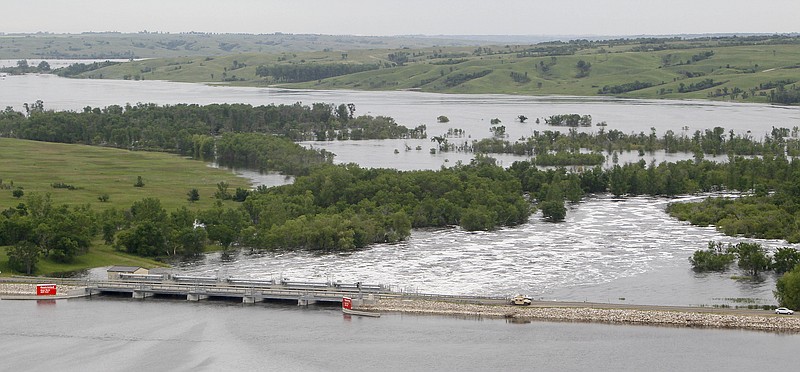 Water from Lake Darling, bottom, passes Friday through the Lake Darling Dam into the swollen Souris River about 19 miles west of Minot, N.D.  The flooding river has reached an all-time high at Minot, breaking a record that stood for 130 years.