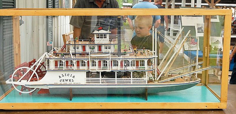 A boy looks over a model steamboat at the Tebbetts Community Picnic. Larry Languell will have his models on display again this year. The picnic runs from today through Sunday at the Tebbetts Community Hall.