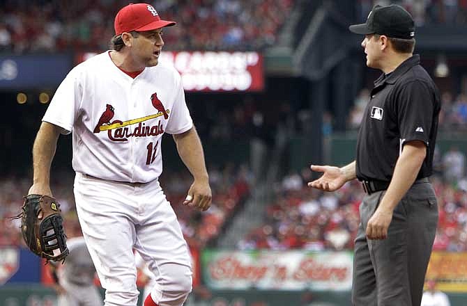 St. Louis Cardinals first baseman Lance Berkman, left, pleads his case to first base umpire D.J. Reyburn after Reyburn ruled Toronto Blue Jays' J.P. Arencibia was safe at first during the third inning of an interleague baseball game Saturday, June 25, 2011, in St. Louis.