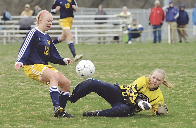 Helias goalkeeper Liz Czarnecki knocks a shot away during a game this season against the Quincy (Ill.) Notre Dame Lady Raiders at the 179 Soccer Park. 