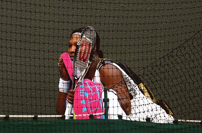 Serena Williams leaves the court Monday after being falling to Marion Bartoli at Wimbledon.