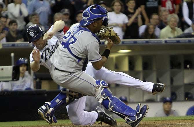 Kansas City Royals catcher Brayan Pena is slammed into by San Diego Padres' Chase Headley in the third inning of a baseball game Monday, June 27, 2011 in San Diego. Headley was out trying to score from first on a double by Ryan Ludwick.