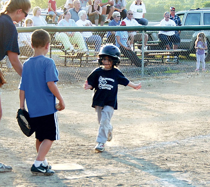 Camryn Wingate is all smiles as she heads home to score one for her team, California Construction, during the CRA T-Ball game Friday night.