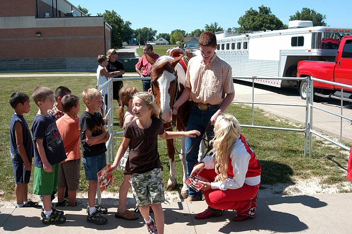 The California R-I Elementary summer school students line up for a chance to pet Warpaint and get a signed card featuring the horse and, Susie, her rider. 