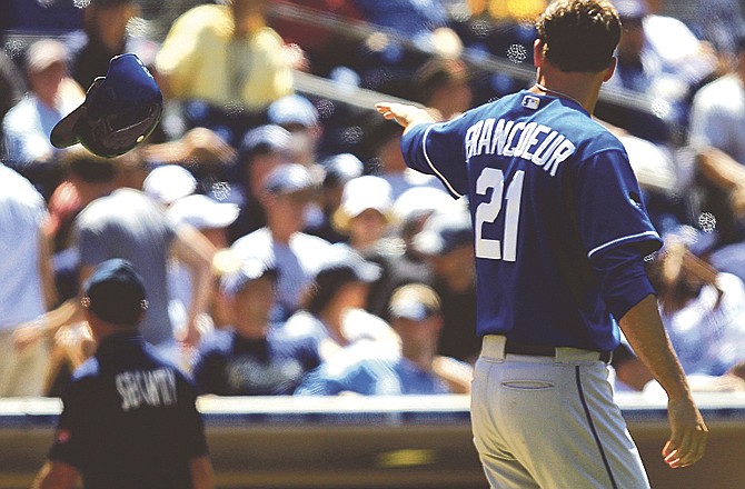 Kansas City Royals' Jeff Francoeur, right, tosses his batting helmet after striking out with two runners on base against the San Diego Padres in the eighth inning of a baseball game on Wednesday, June 29, 2011, in San Diego. It was Francoeur's fourth strike-out of the game. 