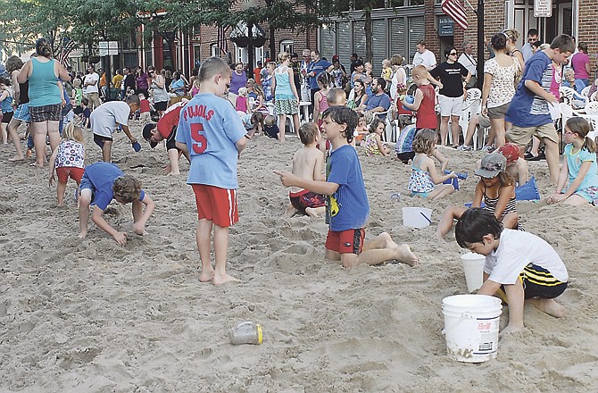 Kids of all ages enjoyed the tons of sand cover a section of Madison Street for the "Thursday Night Live" beach party event. 