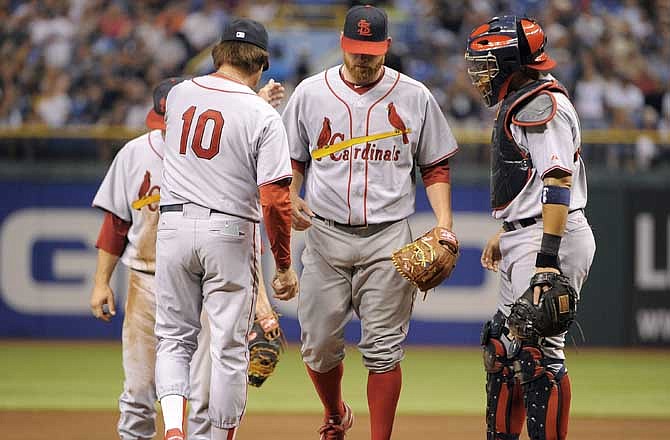 St. Louis Cardinals catcher Yadier Molina, right, wacthes manager Tony La Russa (10) take pitcher Kyle McClellan, center, off the mound after he allowed the Tampa Bay Rays five runs during the sixth inning of a baseball game, Saturday, July 2, 2011, in St. Petersburg, Fla. 