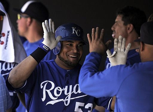 Kansas City Royals' Melky Cabrera (53) is congratulated by teammates in the dugout after hitting a solo home run in the first inning of an interleague baseball game against the Colorado Rockies in Denver on Sunday, July 3, 2011.