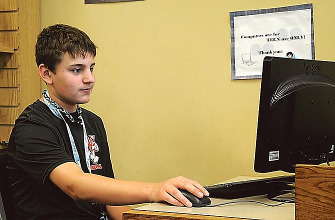 Tristan Clementich uses one of the two new computers at the Teen Zone at the Missouri River Regional Library. The library recently acquired a grant to purchase five computers, including this one.