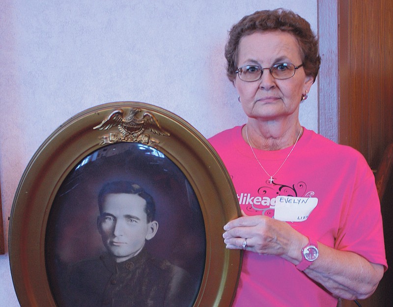 Evelyn Thomas holds a portrait of John Boone Scholl, a great-grandson of Daniel Boone.