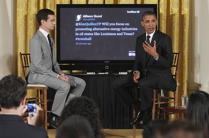 President Barack Obama sits with Twitter co-founder and Executive Chairman Jack Dorsey during a "Twitter Town Hall" in the East Room of the White House.