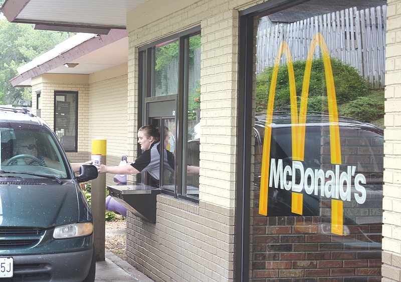 McDonald's employee Alysa Painter hands a customer a drink Wednesday. The Fulton McDonald's will be rebuilt come the first of next year to modernize the layout and building.