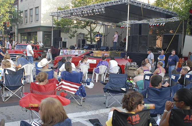 
The "Tom & Dan Show" band performs on stage as a crowd fills High Street from Jefferson to Monroe Street for a "Thursday Night Live" event in June. Questions are being raised of Jefferson City officials about the ability of organizers to prohibit citizens from engaging in petitioning or political activities within the festival districts created for such events.