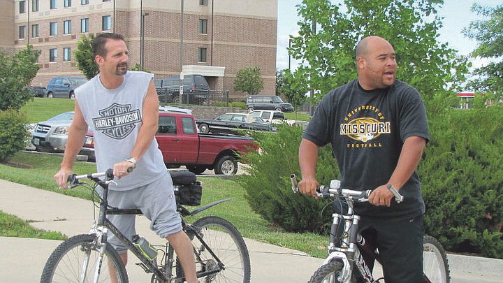 Wake Up, Columbia host Tom Bradley (left) and producer Jeremy Washington take a break during the biking portion of their triathlon on June 23. Bradley and Washington, a Fulton native, raised nearly $1,000 between them during the three week event.