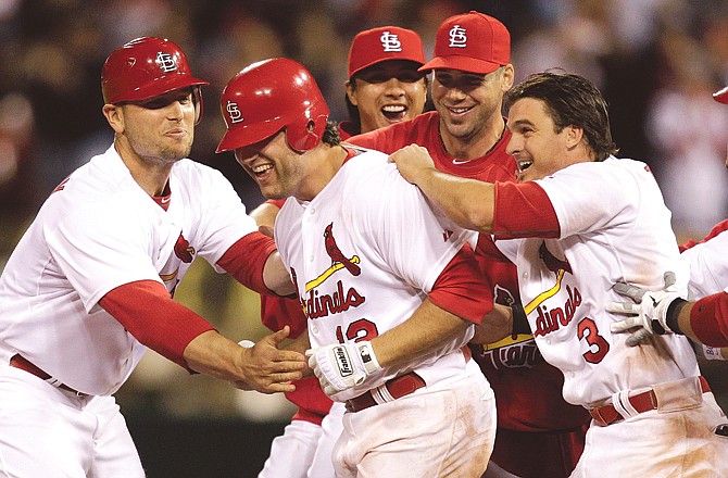 Lance Berkman (second from left) of the Cardinals is congratulated by teammates (from left) Matt Holliday, Kyle Lohse, Chris Carpenter and Ryan Theriot after hitting a walk-off single to defeat the Phillies 2-1 during the ninth inning of a game in St. Louis. Berkman was a big question mark when the Cardinals signed him to a one-year free agent deal last winter.