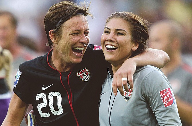 Abby Wambach (left) of the United States and goalkeeper Hope Solo celebrate winning their quarterfinal win Sunday over Brazil at the Women's Soccer World Cup in Dresden, Germany.