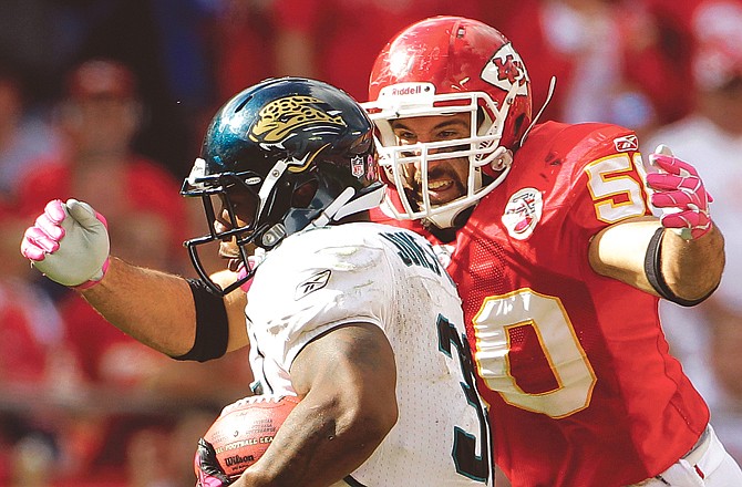 Jaguars running back Maurice Jones-Drew is tackled by Chiefs linebacker Mike Vrabel during the fourth quarter of a game in Kansas City. Vrabel announced Monday he is retiring from the Chiefs and returning to his alma mater as an Ohio State assistant coach.