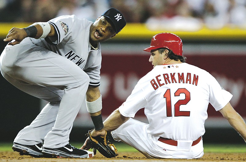 Lance Berkman of the Cardinals is tagged out at second base by Robinson Cano of the Yankees during the second inning of Tuesday night's All-Star game in Phoenix.