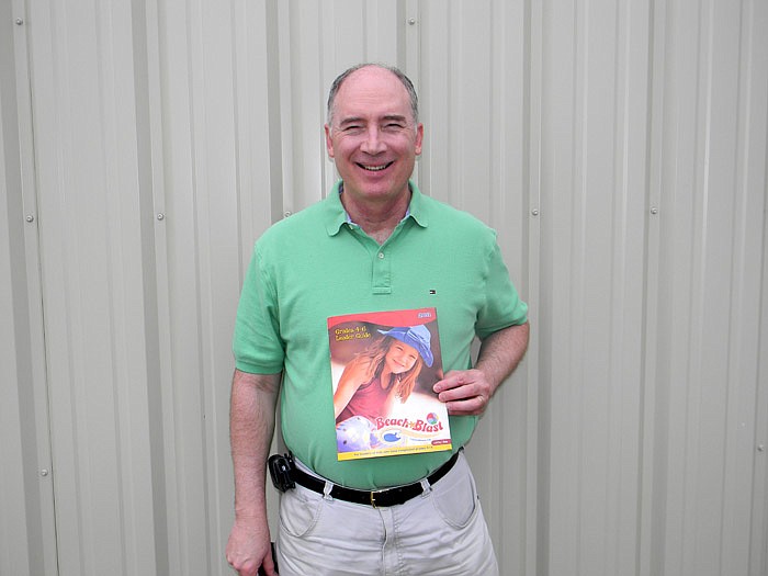 Lupus Baptist Church Pastor Tim Redmond, with the Beach Blast VBS booklet which will be one of two free events on concurrent weeks the church will host to reach out to the surrounding community. The first will be a benefit concert by Redmond on Friday, July 15, at 6:30 p.m., and the VBS will be Wednesday, July 20 through Friday, July 22, starting each day at 5 p.m.