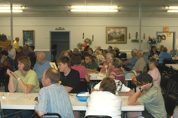 Contestants at the Finke Theatre trivia contest listen to a question before considering an answer.